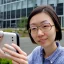 Placeholder: A short haired, bespectacled Japanese female software engineer taking a selfie in front of Building 92 at Microsoft in Redmond, Washington