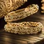 Placeholder: Elegant and intricate gold wedding bands with diamond accents