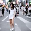 Placeholder: beautiful woman in Tokio street in short skirt and white t-shirt