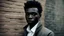 Placeholder: a man standing in front of a brick wall, man is with black skin, dramatic portraiture of namenlos, dramatic lighting man, dramatic intense lighting, dramatic portraiture of uuen, by Emma Andijewska, dark black skin tone, black teenage boy, posing in dramatic lighting, dark skin, sharp black skin, inspired by David Bailly