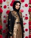 Placeholder: Luxury potrait of a beautiful super model hijab beauty makeup cosmetic,she wearing islamic a luxurious details pattern color gold and black casual jacket with designed large flower details that resemble roses.The dress has an asymmetrical design with one sleeve and a flowing skirt.background of the image shows a red carpet event with floral decorations,close-up portrait