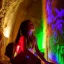 Placeholder: A dirty native American girl in a cave doing wall paintings with glowing lights