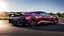 Placeholder: A rear view sleek (((challenger veneno))), with its iconic design and powerful contours, elegantly poised against a (sunny, blue sky, road)