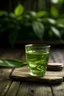 Placeholder: GREEN TEA LEAF AND GREEN TEA GLASS CUP IN WOODEN TABLE .GREE TEA FARM BACKGROUND