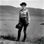 Placeholder: [art by Russ Meyer] Lee Miller stands with her camera in the battlefield. she shows off her garters. This war photographer is a fascinating figure indeed. She captured powerful images during World War II, showcasing the realities of conflict with a unique perspective. Her work is a testament to the courage and artistry of photojournalists in documenting history.