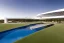 Placeholder: algarve in quinta do lago, one straight line building of 250 meters long pool of a modern luxury architecture with wood and gold metallic pergolas with pool on rooftop, overlooking a slope with pinus pinea