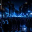 Placeholder: dark city at night, lots of people, blurred,