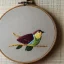 Placeholder: exquisite whimsical birds in embroidery hoop, intricate, highly detailed, linen and wood backdrop