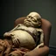 Placeholder: a chubby extremely mummified male corpse, eyes closed, leaned over in a brown chair