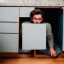 Placeholder: man hiding under cabinet