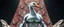 Placeholder: brilliant detailed full figure portrait disco glittery goose slug alien fluffy muscle man dino anime in the style of Escher and Giger in front of dented marble tower of glitter