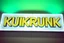 Placeholder: A 1980 disco sign labeled "KUKRUNK" white background and bold 80s font