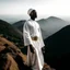 Placeholder: African man in white thobe, standing on top of mountain