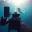 Placeholder: photobomb, picture of a scuba diver taking a selfie underwater, far behind the diver in the far background is a fantastical beautiful mermaid swimming, photoreal HD quality, depth of field