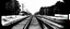 Placeholder: view of Railroad tracks passing from side to side , black and white, oval fade boarder vignette