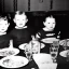 Placeholder: Creepy old photo of ginger alien people sitting at dinner with weird children