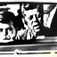 Placeholder: JFK and batmmat drive the batmobil