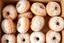 Placeholder: a box of fresh old-fashioned mini doughnuts completely covered in powdered sugar