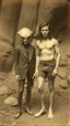 Placeholder: An old picture style of white and brown and very bad quality old camera with cracks of Tarzan standing with an Alien who is wearing a suit, the year 1900