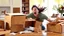 Placeholder: woman starts frantically tearing through a very large box the kitchen table was delivered in