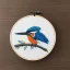 Placeholder: kingfisher in embroidery hoop, intricate, highly detailed