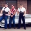 Placeholder: a 50s Greaser BAND standing in front of a hot rod