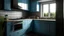 Placeholder: kitchen with blue, on the left side by the window from the bottom up, a microwave and an oven installed in the furniture, and on the right side and next to it an induction hob and a cooker hood above it, on the right side there is a sink and a dishwasher underneath it