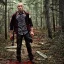 Placeholder: georges st pierre with a red plaid shirt, a backpack and a rifle in a creepy forrest with zombies