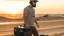 Placeholder: short beard man with cap, DJ play records ,full body, speakers, at beach, dunes background, sunset