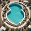 Placeholder: a surreal aerial perspective of a suburban pool shaped as a long cylinder with two circular hot tub pools jutting out at one end, photograph, beautiful composition, humorous, whimsical