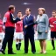 Placeholder: Angela Merkel in a referee jersey officiating for a soccer match at Wembley Stadium