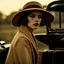 Placeholder: A woman wearing a brown felt hat with a metallic strap and an elegant beige coat or dress sits on the hood of a black Ford T. She has a pensive, somewhat melancholic expression on her face. The lighting and styling of the image evokes a vintage nostalgic aesthetic reminiscent of the 1920s or 1930s. The figure and refined appearance of the woman suggest a certain grace and sophistication typical of that period.