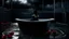 Placeholder: "A sleek, modern bathtub sits against a dark, noir-inspired backdrop of a stormy night. The sky is a deep, ominous black, with flashes of lightning casting a stark white light over the scene. A solitary figure stands beside the bathtub, silhouetted against the darkness, with a red rose floating in the water. The atmosphere is dramatic and mysterious, with a focus on high contrast and deep shadows."