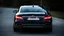 Placeholder: Full image of the rear view of a black Mercedes-Benz CLS with lights on