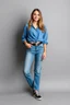 Placeholder: simple background a beautiful young lady wearing jean pants and blue blouse full body standing pose,sport shoes