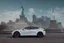 Placeholder: A Tesla 'Model S' is drifting at top speed, near the 'Statue of Liberty' in New York. CINEMATIC. WIDE ANGLE LENS. PHOTO REAL.