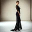 Placeholder: Full-body fashion editorial photograph of an elegant and beautiful woman. She is wearing a sophisticated, delicate black lace evening gown with modest coverage and matching high heels. Captured in a high-end luxury studio setting with soft, dramatic studio lighting that highlights the texture of the lace. Graceful posture, professional model pose, realistic skin textures, cinematic atmosphere, haute couture style.