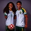Placeholder: 85mm DSLR color photography of a very detailed headshot fitting all of head and hair in frame. 23-year-old Brazilian soccer player, with and with no facial hair and has a with a small smile, grey background has a soft look on his face has smooth long hair has rose-tan skin tone