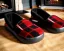 Placeholder: Red plaid slippers on black bearskin rug,log cabin walls, stone fireplace