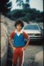 Placeholder: eleven year old mediterranean boy dressed track pants, early 80's color photo