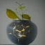 Placeholder: photo of a small cracked ceramic vase repaired with gold, kintsugi, beautiful, vines and leaves, rosebuds, delicate, cinematic, high detail, beautiful composition, delicate arrangement, aesthetic, soft lighting, award winning photography, tender