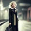 Placeholder: A beautiful slender well dressed young caucasian woman with short blonde hair and a black trench coat, waiting for a man at night at a train station in London