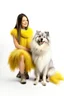 Placeholder: large white dog in a feather dress, next to a girl in a yellow sweater, a gray skirt, white stockings and black shoes, both facing the front in the photo. white background, 16K, real photography, portrait.