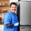 Placeholder: Refrigerator repairman is smiling and working on the big refrigerator