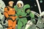 Placeholder: Create a vintage-style sci-fi image featuring a muscular male character with blond hair and a determined expression, dressed in a form-fitting, orange space suit with black belt, standing on a green, disc-shaped spacecraft. In close combat with a large, silver humanoid robot that has visible joint segments, round head, a flat face with two large circular eyes, and a small round mouth. The robot's right hand is raised while its left hand is gripping the protagonist's right forearm. The human char