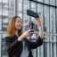 Placeholder: A short haired, female computer engineer taking a selfie in front of Building 92 at Microsoft