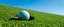 Placeholder: left side macro photo of a golf green, golf ball with shadow next to the hole(circular, dark inside), ground is short groomed green grass, clear blue sky, add texture and depth, realism