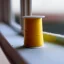 Placeholder: spool of thread on windowsill