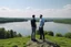 Placeholder: An image of two people exchanging criticism in a constructive and respectful manner, standing on a hill with a lake behind them 4K