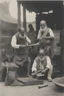 Placeholder: A Indian blacksmith seat on ground and work something with a Indian king standing in front of him and a bag of sandalwood on one side, the king pointing towards the Bag.